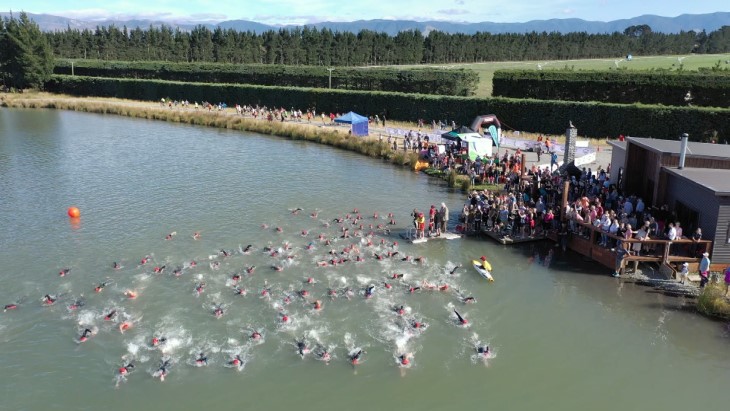 Swimmers in the OxMan triathlon take to the water