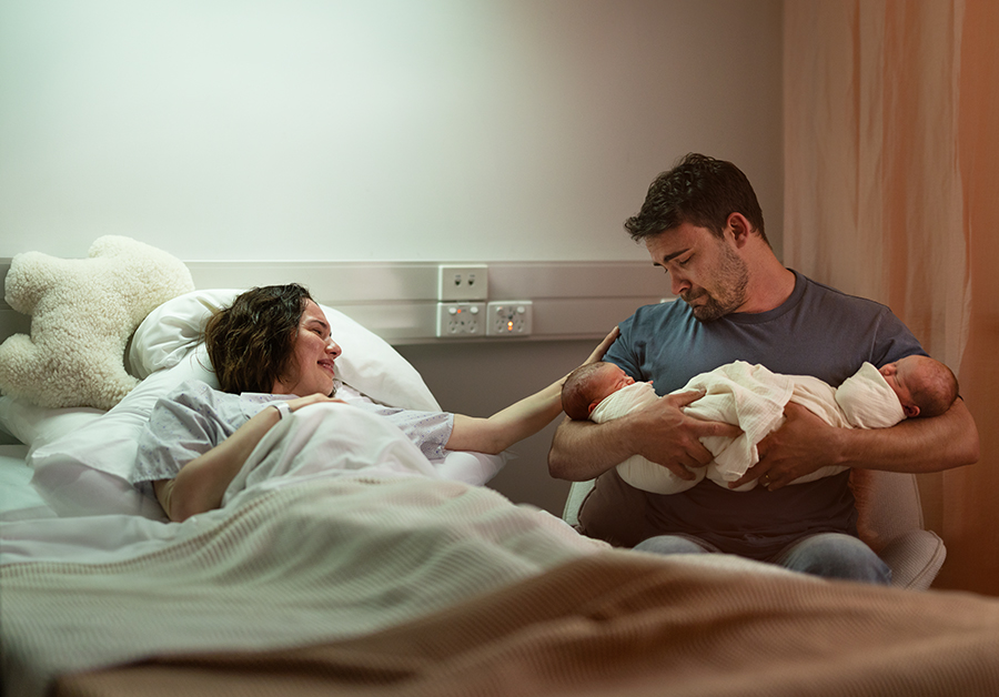 Man having a hmmm in front of waterfall with friends in background looking on