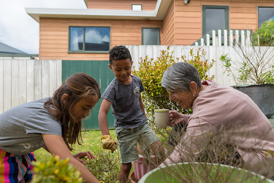 Grandmother gardening with grandchildren