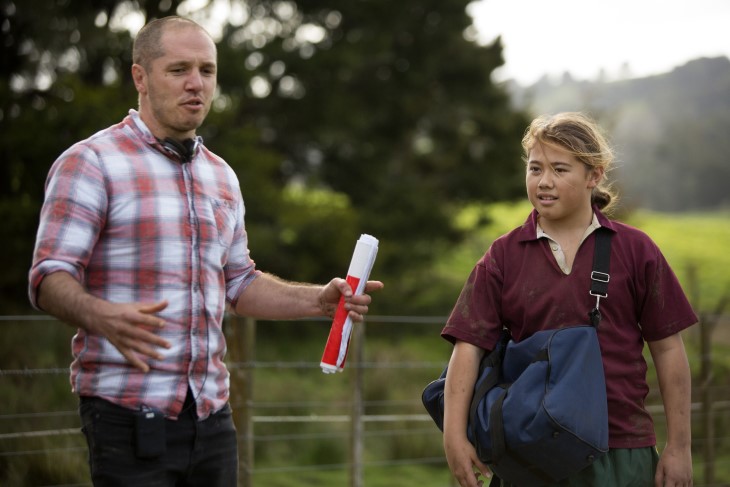 Hamish Bennett directs an actor on set on a farm