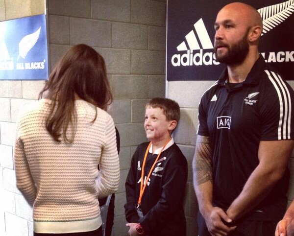 A young Brayden stands with an All Black