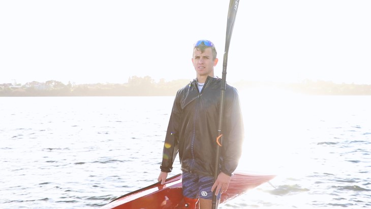 Corbin Hart carries his kayak from the water