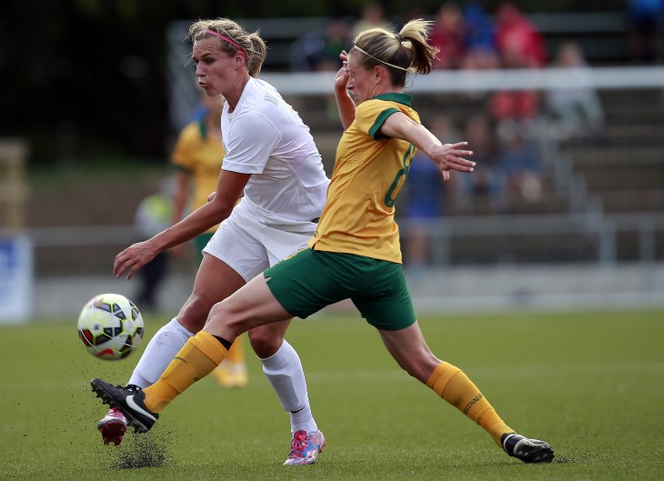 Two female footballers fight for the ball