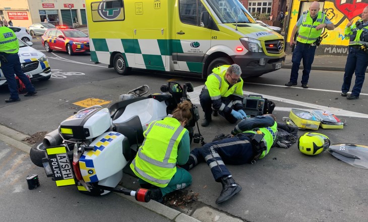 Johnny McGrail lies at the scene of his bike crash surrounded by ambulance staff