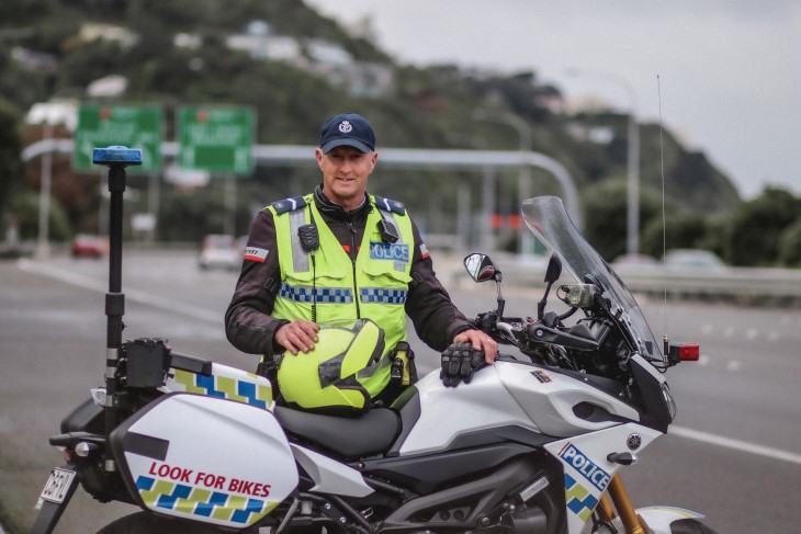 Johnny McGrail poses by his police bike on a Wellington highway