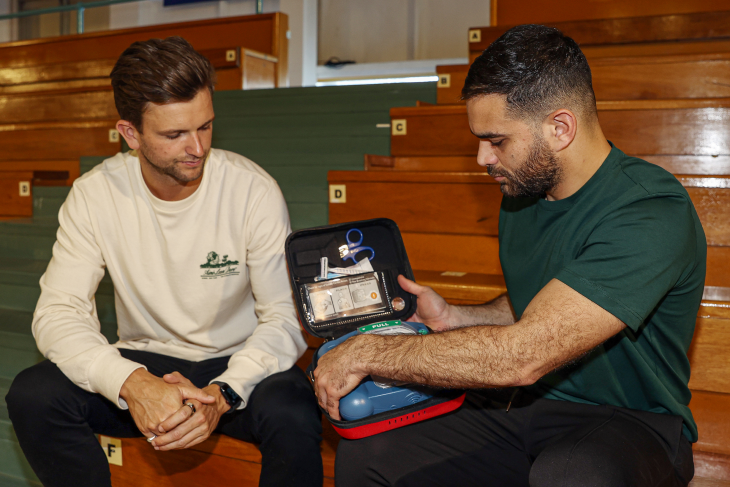 Josh watches Kareem unpack the AED