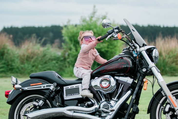 Harley sits on a Harley Davidson motorbike 