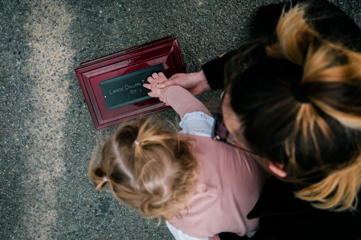 Kavana and young Harley place their hand's on Lance's ashes