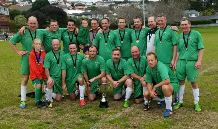 Football team in green kit winning trophy