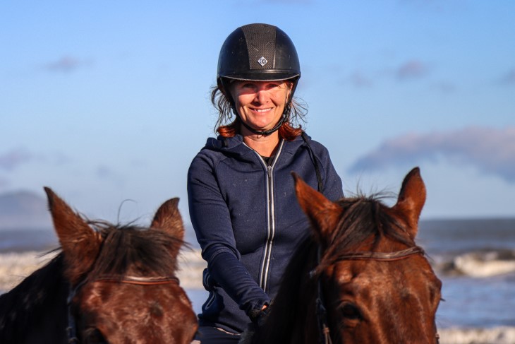 Lenka smiles at the camera on her horse