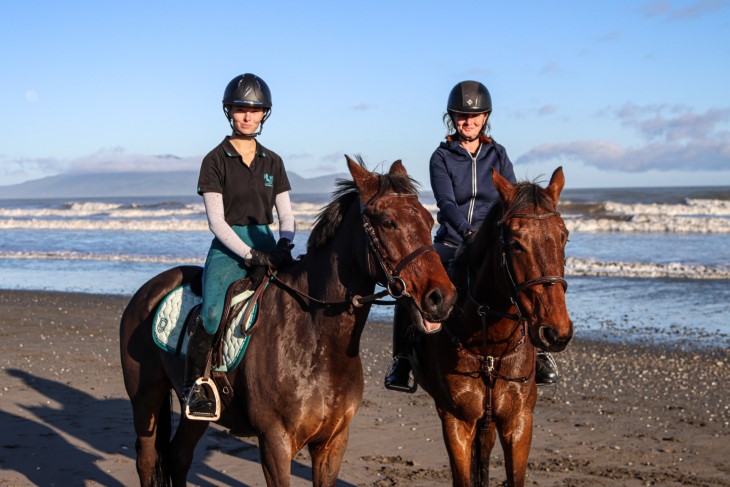 Lenka and her daughter Paris pose on their horses on the beach