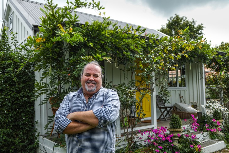 Martin Bosley poses in front of his cottage home