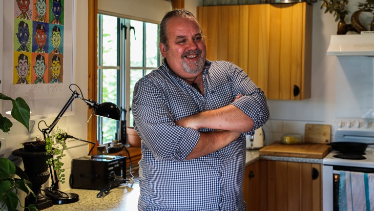 Martin Bosley laughs in his kitchen