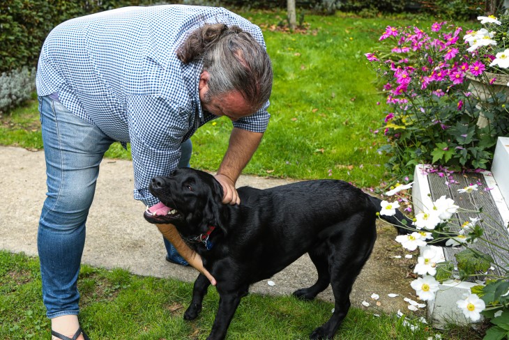 Martin gives his dog a belly rub