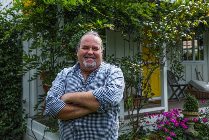 Martin smiles outside his cottage