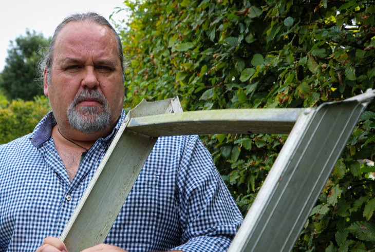 Martin looks over the broken ladder that cut him