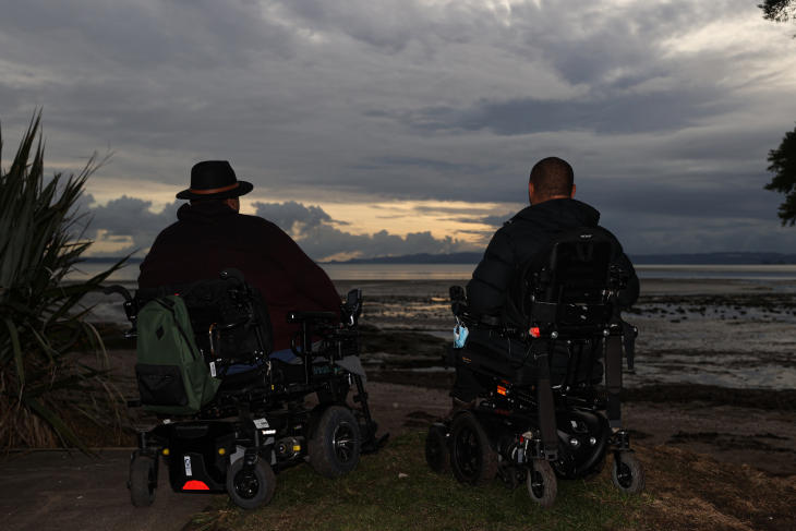 Lee and his friend look out into the dusk sky