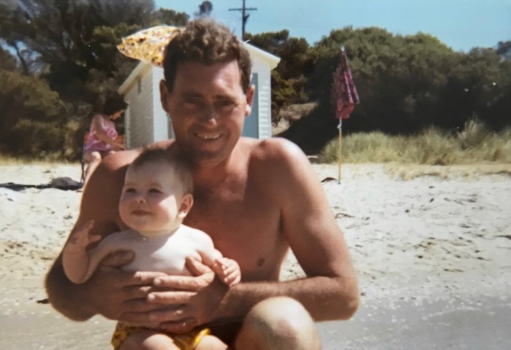 Megan's Dad holds her as a baby