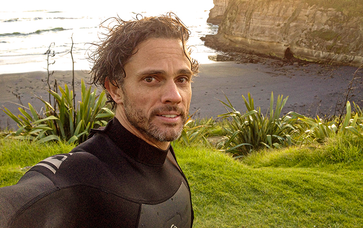 Mick Andrews stands on a beach