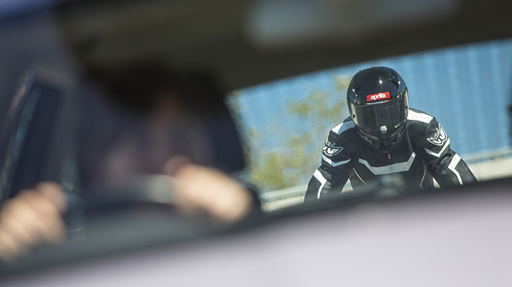 Driver sees motorcyclist in rear-view mirror