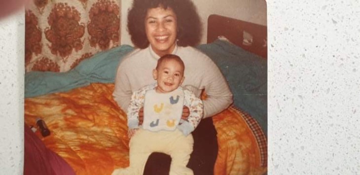 PJ as a baby on a woman's lap
