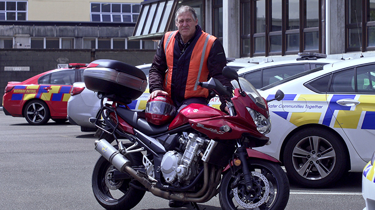 Peter Sowter stands behind his motorbike