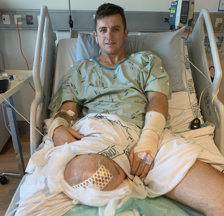 Corbin Hart lays on his hospital bed post-surgery