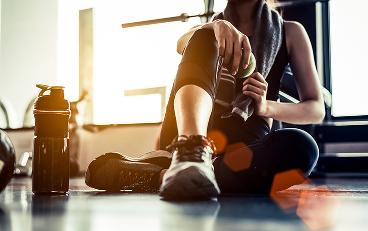 Women sitting on the floor resting after a gym session