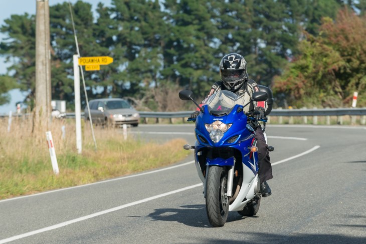 Rider heads past a New Zealand country road
