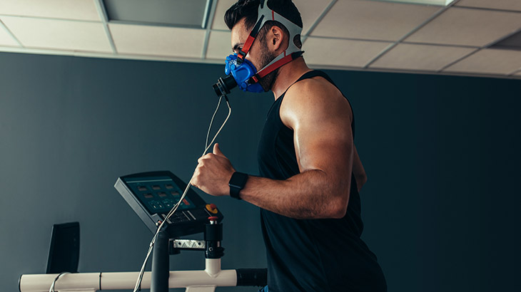Man on treadmill with breathing apparatus