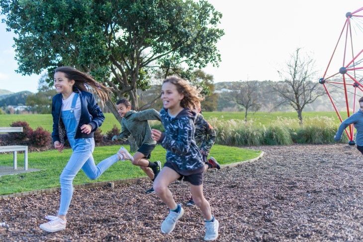 Young children run from a playground