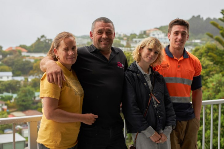 Todd and his family stand on their deck