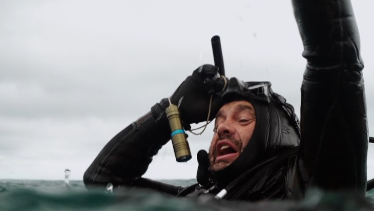 Todd Russell waves for help in the sea