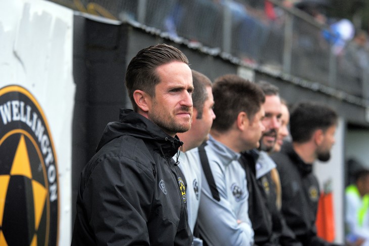 Coach José Manuel Figueira watches from the sideline.