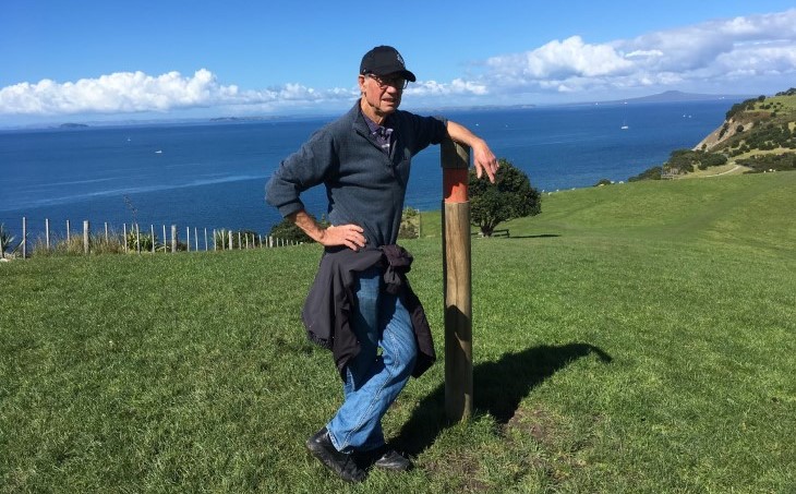 Trevor Markham rests on a post on top of a hill