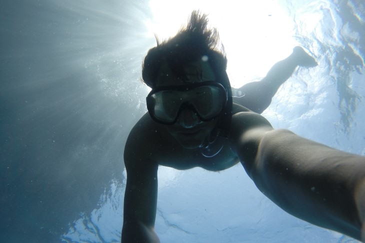 Young man dives underwater
