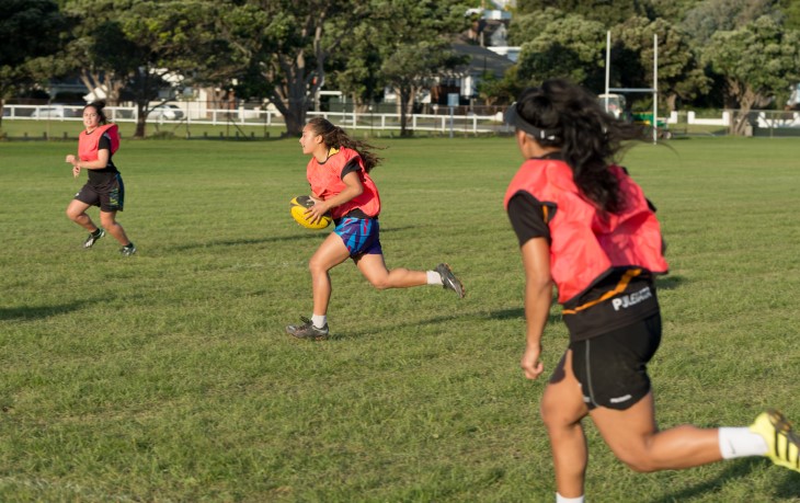 Young women play touch rugby