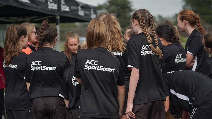 Kids have a huddle in their ACC Sportsmart kit
