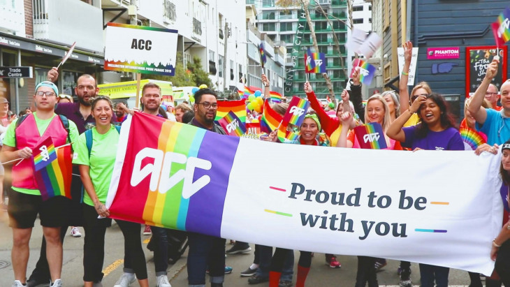 People holding sign at Pride Parade