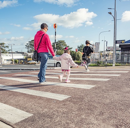 Family crossing the street