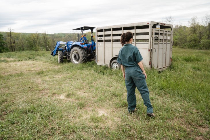 Farmer working by trailer