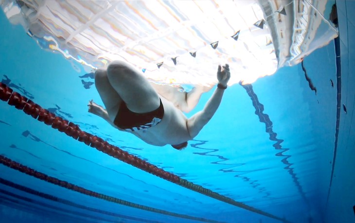 Ian Winson floats on his back in a swimming pool.