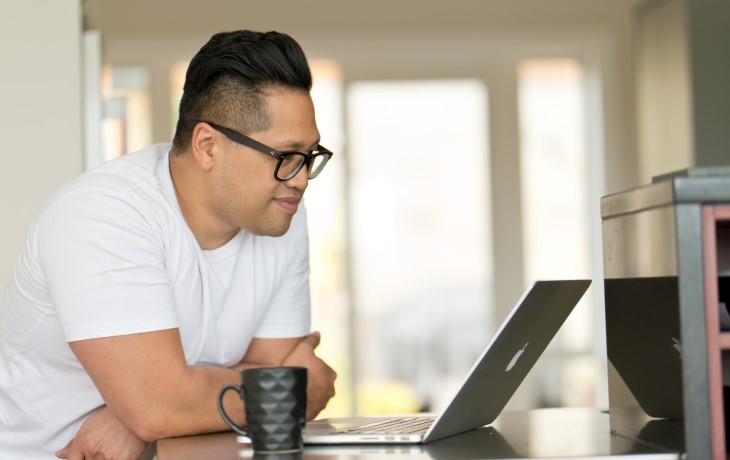 Person at home looking at laptop