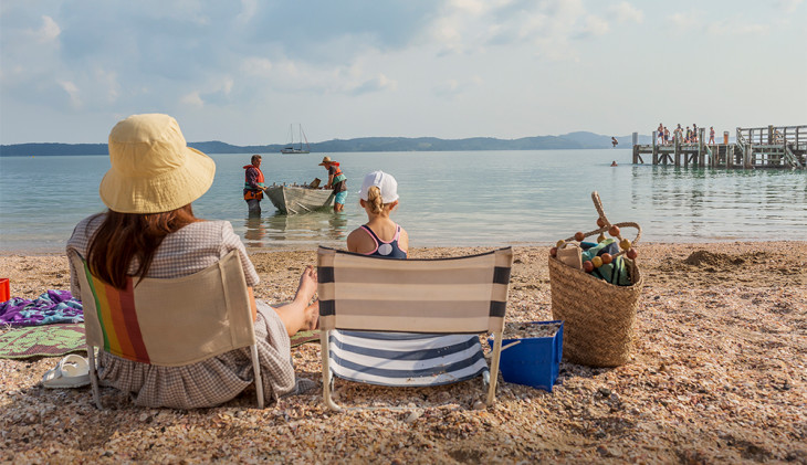 Mum watches swimmers at the beach