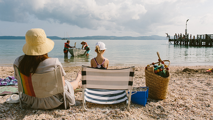 people sitting on beach newsroom