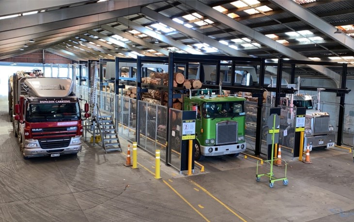 Logging trucks going through the robotic scaling machine checkpoint.