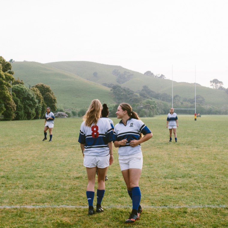 A woman's rugby team running sprints