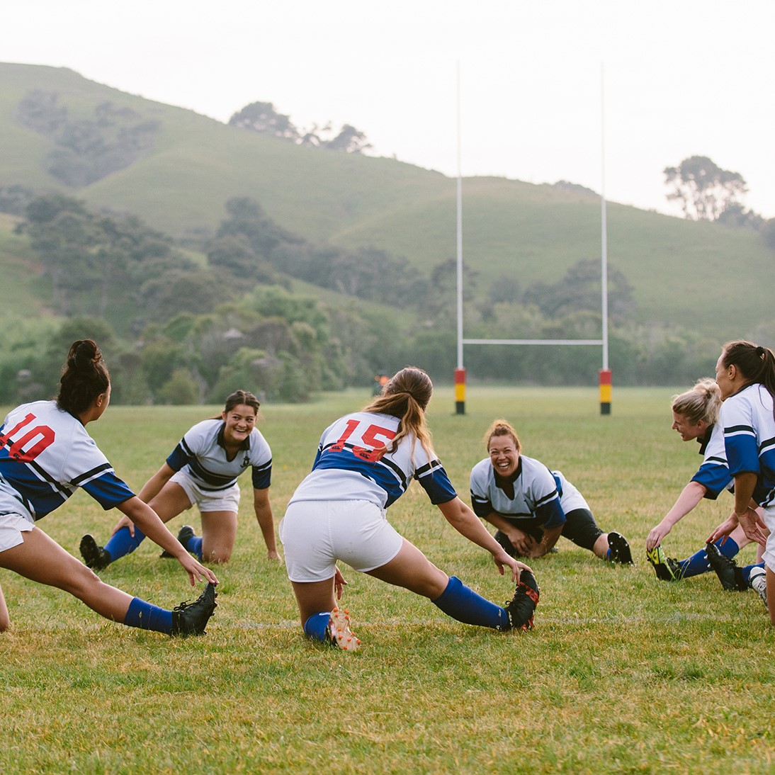 A women's rugby team stretches before the game.