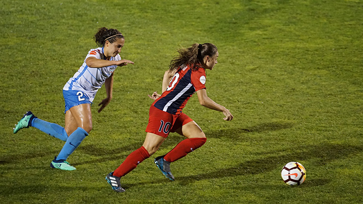 Image of two young women playing football