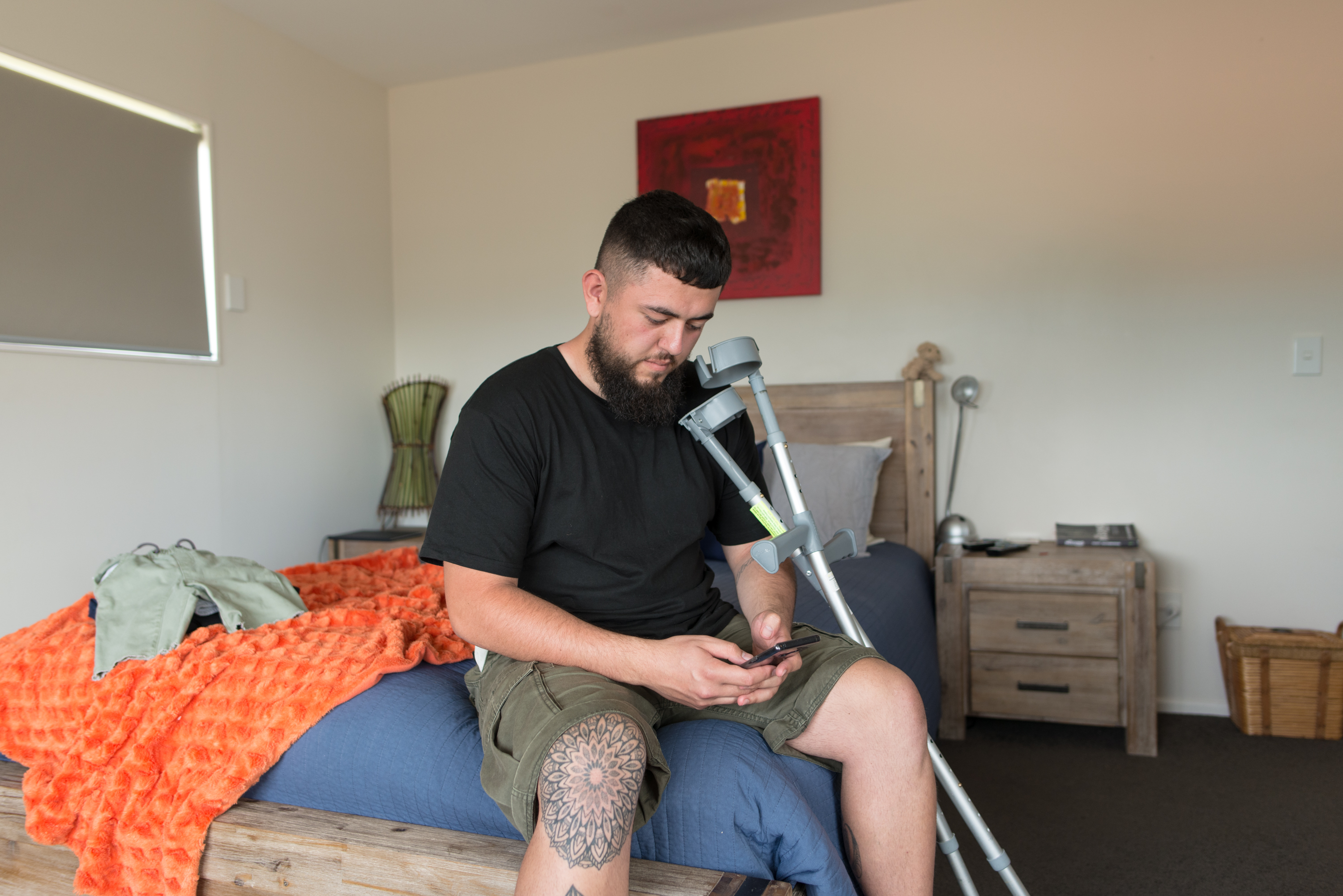 152638 injured man on phone 2 Injured man looking at phone